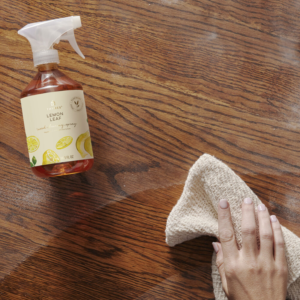 Thymes Lemon Leaf Wood Cleaning Spray on table in use image number 2
